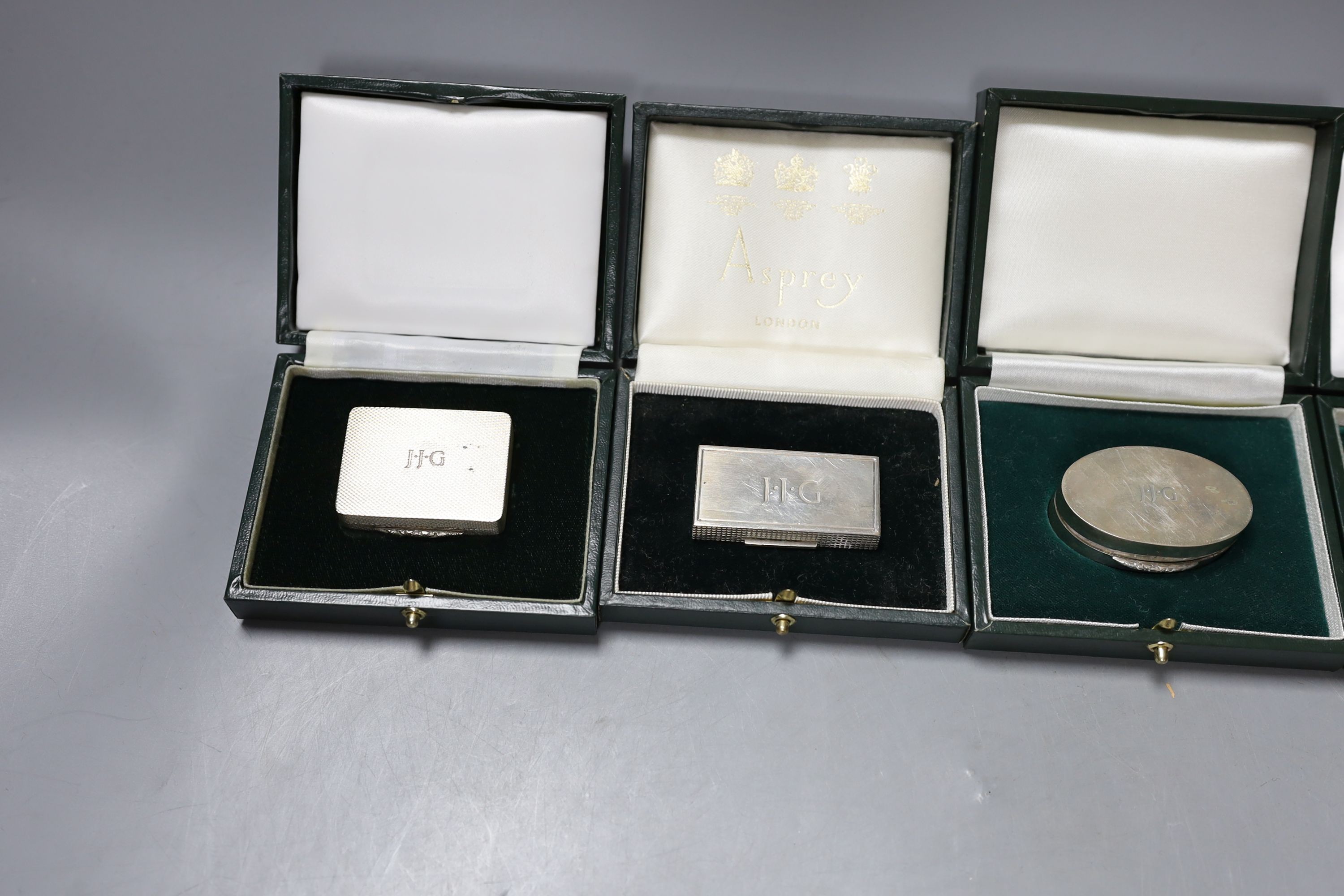 Six assorted modern cased silver or parcel gilt silver pill boxes by Peter John Doherty, Birmingham, 1969-1996, largest 5cm, all in fitted Gallagher boxes, one by Asprey.